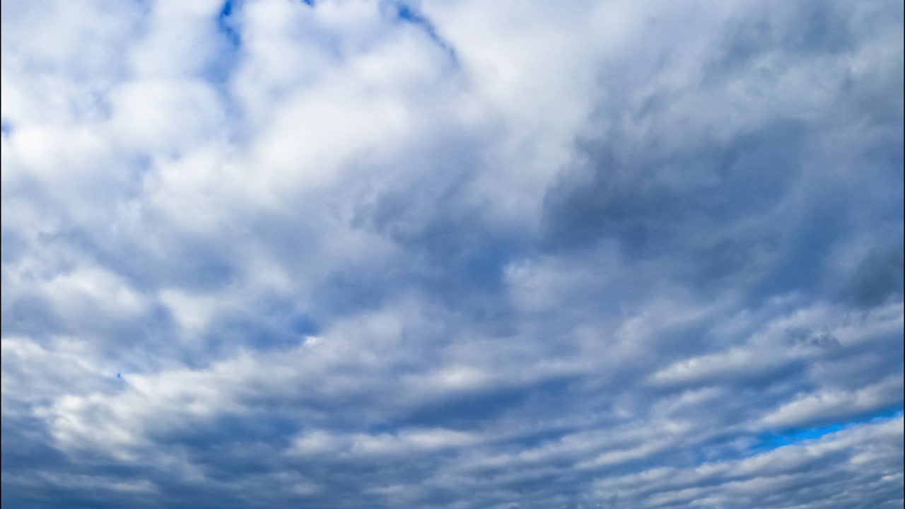 Thick layer of grey clouds hiding the skies. Heavy cloudscape forming the rain. Low angle view.