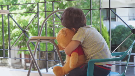 A-two-years-old-boy-hugs-his-stuffed-bear