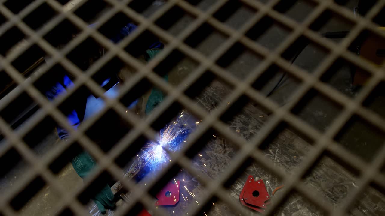 Female welder using blowing torch on a rod 4k