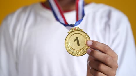 child receiving a gold medal