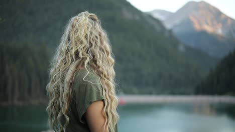 slow motion shot of a happy beautiful blonde female overlooking a gorgeous scene in the mountains-3