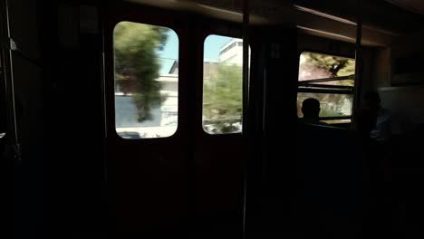 Inside-View-From-The-Window-Of-The-Moving-Overground-Train-Carriage-in-Athens,-Greece