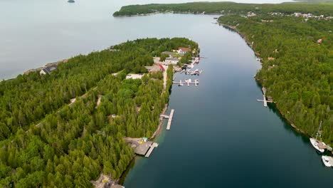 Aerial-view-of-golden-hour-at-Big-Tub-Harbor,-Tobermory,-Ontario,-Canada