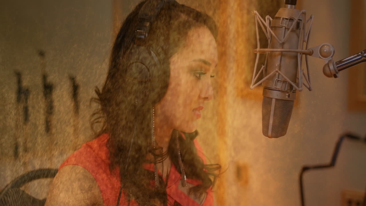 Female vocalist sitting in music studio, showing floating waveform animations above microphone