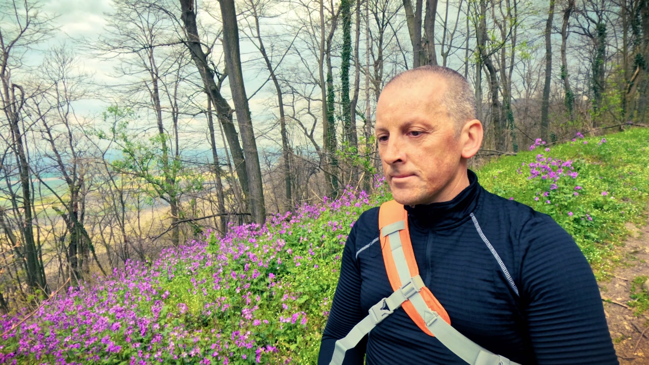 Travelers with backpacks walking through a scenic woodland path. Highlighting local tourism, weekend getaways, sightseeing, and outdoor exploration.