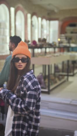 stylish woman using phone in a shopping mall