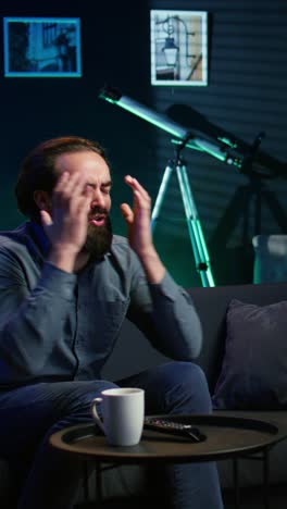 vertical video furious sports fan in disbelief during match broadcast after team fails to score