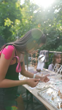 teenager browsing jewelry at outdoor market