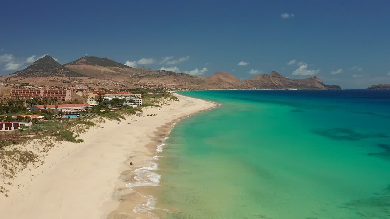 Aerial shot couple walking on the beach Porto Santo, Madeira, Portugal