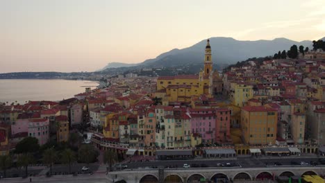 colorful buildings on breathtaking menton coastline at sunset - establishing aerial