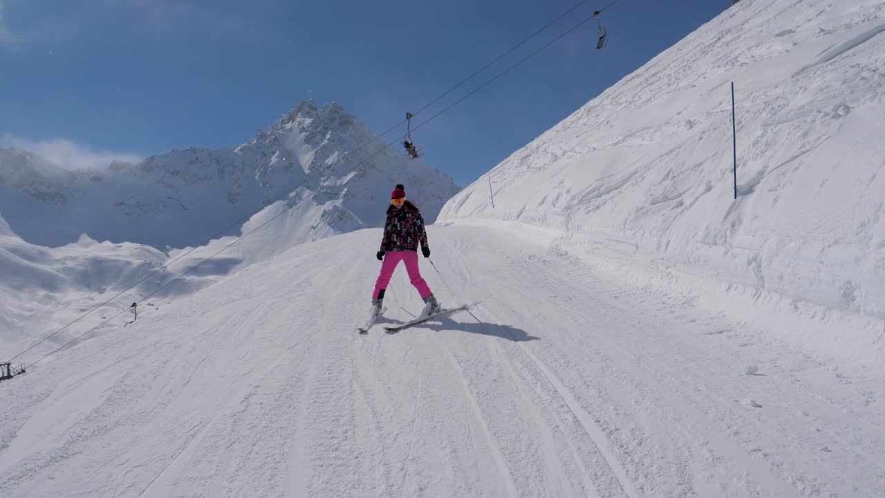 Skier Woman Slowly Skiing Down On Ski Slope In Mountain