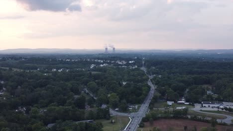 sun setting over housing development power plant in background