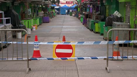 a sign and barrier prohibiting access warning the public of a locked-down area to contain the spread of the coronavirus variant outbreak in hong kong