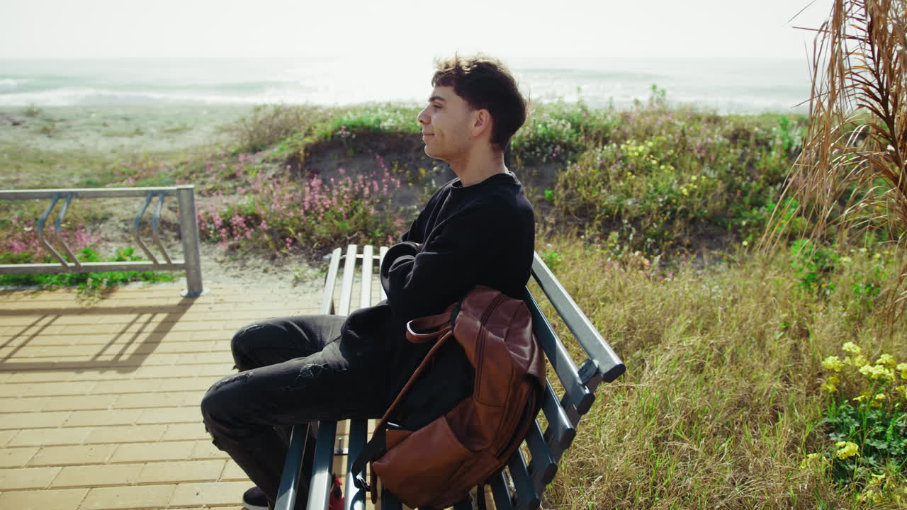 Man On The Bench Near The Sea Relaxing And Enjoying The Nature