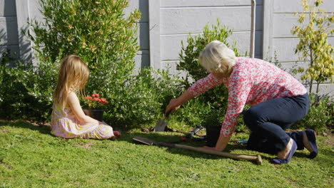 grandmother and granddaughter planting in garden 4k