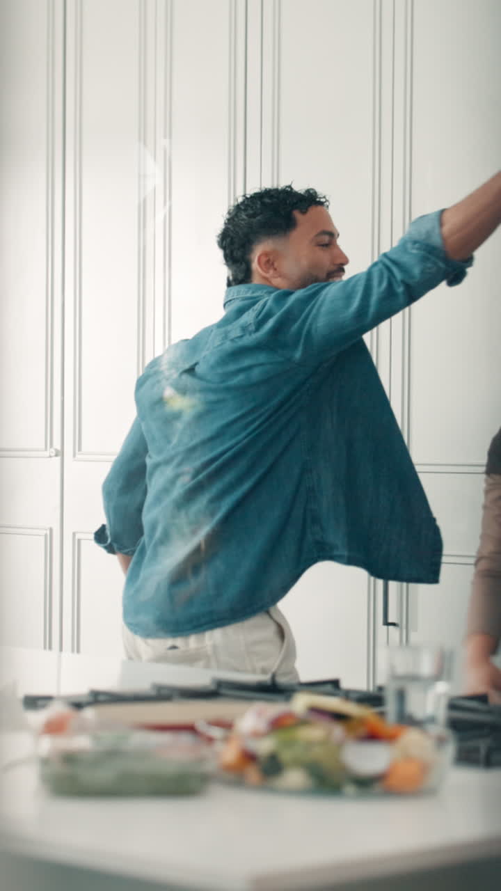 Man and Woman High-Fiving and Laughing in a Modern Kitchen
