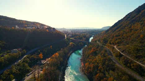 Stunning-aerial-4K-drone-footage-of-Solkan-arch-bridge-over-the-Soča-river,-a-majestic-stone-marvel-located-in-western-Slovenia