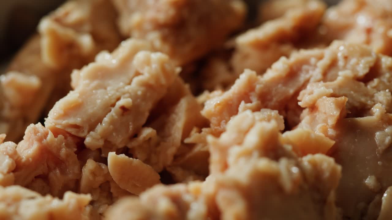 Smoked cod liver in oil in open tin can with fresh greens on wooden table. Seafoods delicacy. High quality 4k footage
