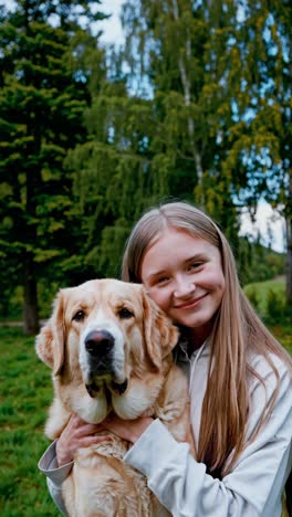 young woman embracing her lovable golden retriever in a tranquil park, sharing a joyful moment of connection while surrounded by the beauty of nature and greenery