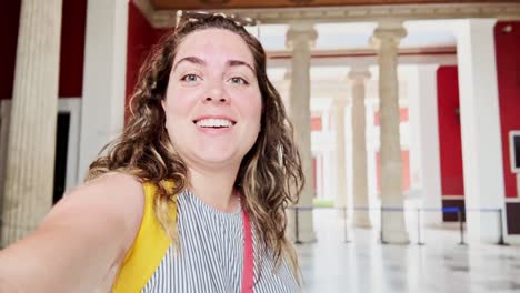 cheerful woman smiling broadly inside zappeion hall
