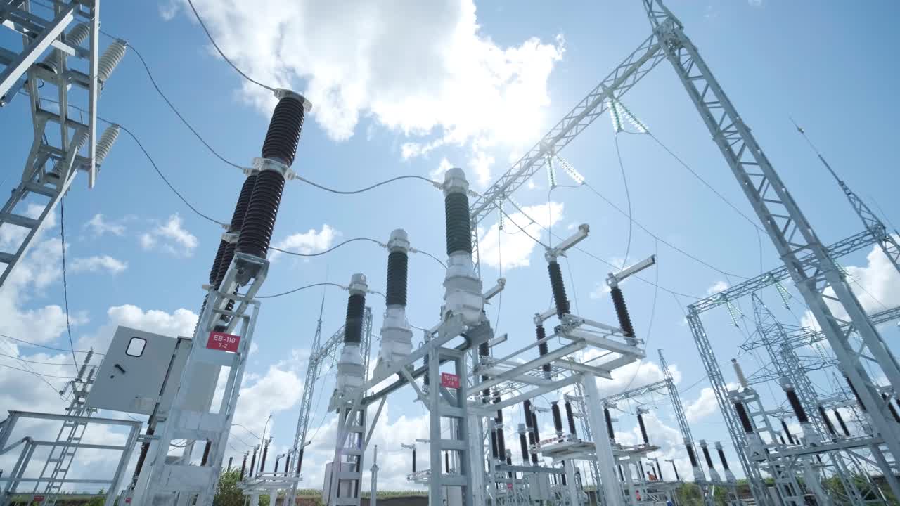 High voltage transformer against the blue sky. Electric current redistribution substation
