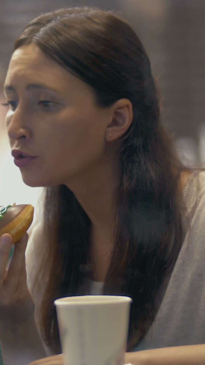 A woman eating a donut