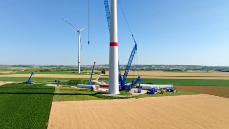 construction site of a wind turbine green energy generation in austria - drone shot