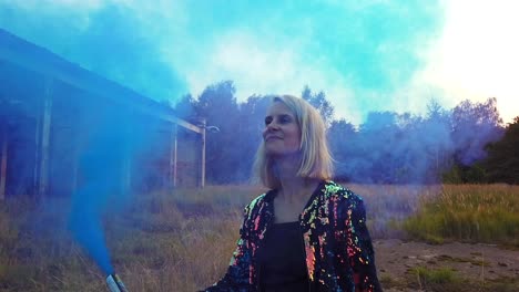 perfect slow motion cinematic shot of a girl in front of a tank hall.colorful fog shooting russians airplane hangar. gimbal foto video shoot on lost places in wild nature 1080, 24p by philipp marnitz