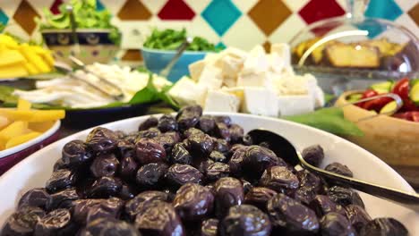 breakfast buffet with olives, cheese, and fruits