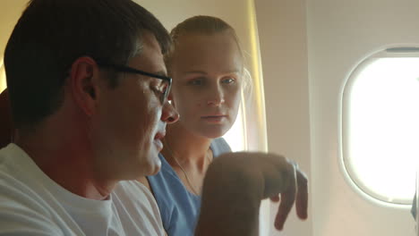 young couple talking in the airplane