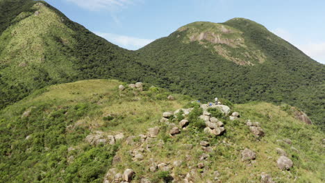 Aerial-view-of-hikers-resting-on-a-rainforest-tropical-mountain,-Brazil,-South-America