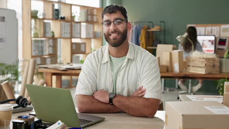 man working in an office with a laptop surrounded by boxes