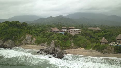 Beautiful-drone-shot-of-the-jungle,-river-and-beach-in-Tayrona-national-park-in-Colombia