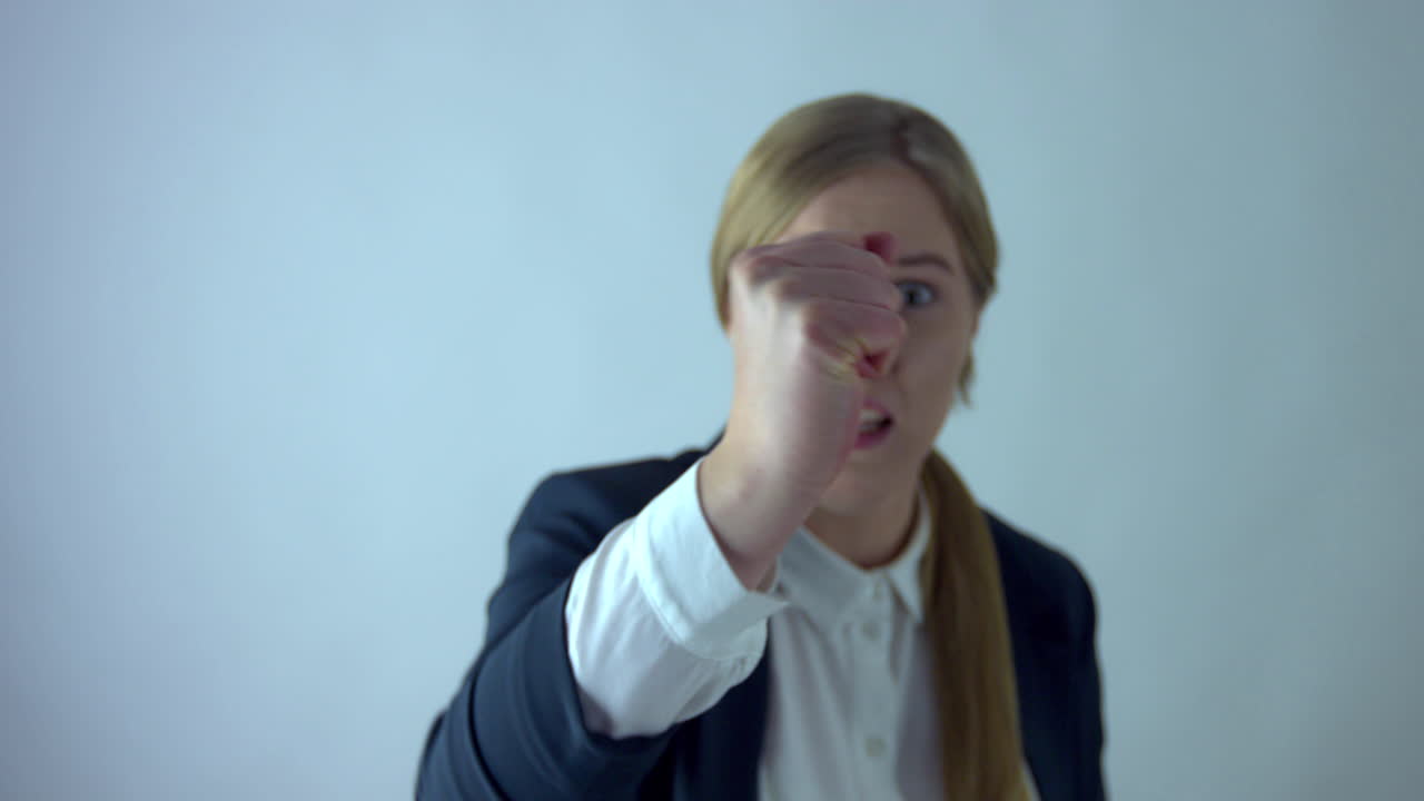 Businesswoman hitting screan with fist like there was some virtual emergency button
