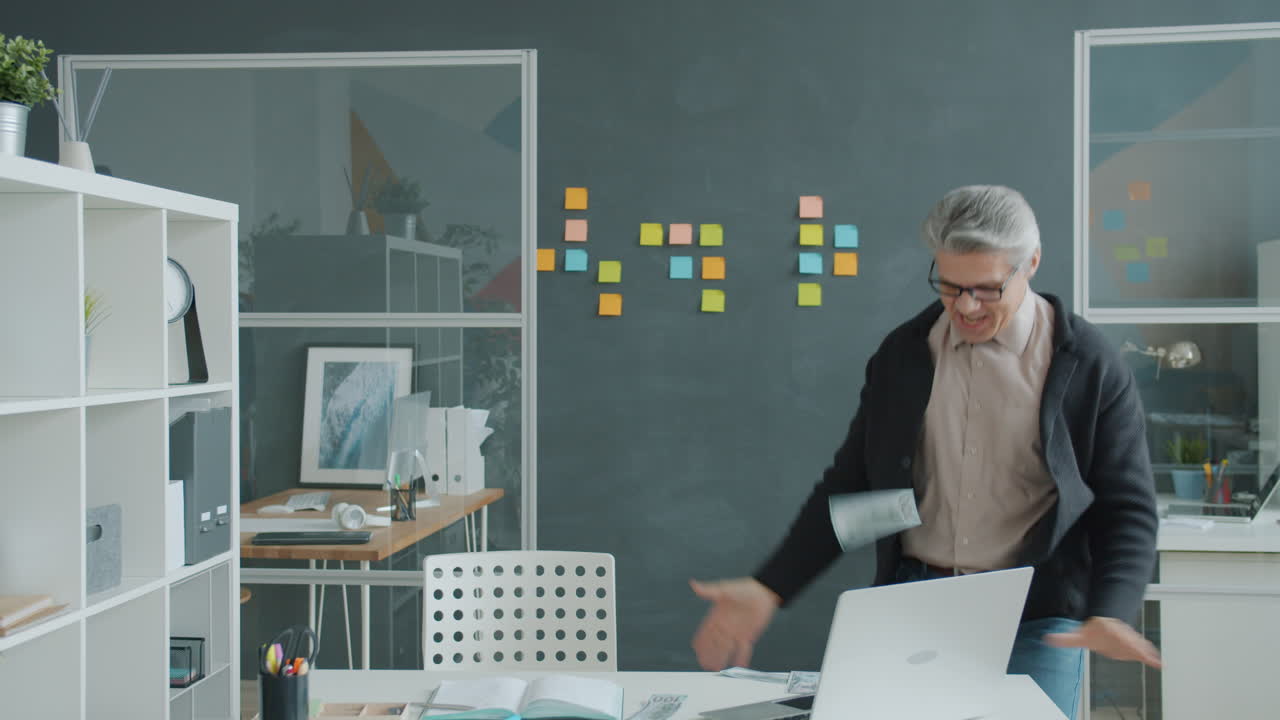 Un uomo d'affari felice che celebra il successo in ufficio