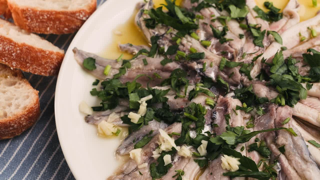 Fresh Sea sardines and Anchovy Fish and Mullus On Display On Ice On Market Store Shop. Seafood Fish Background, close up stand of small salty white fish.