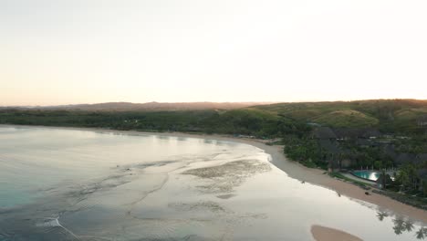stunning scenery of a tropical lagoon in fiji during sunrise, aerial footage