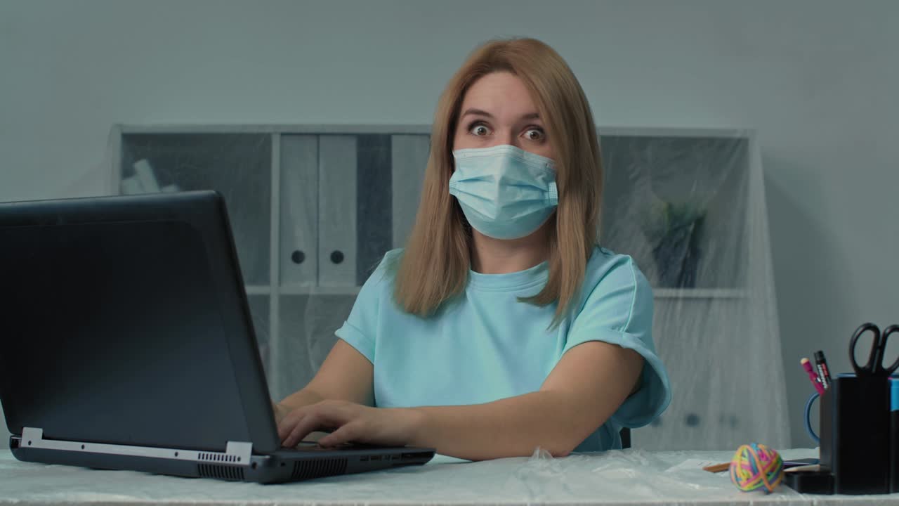 A business lady in office works at a computer. She saw the values of some indicators and was surprised.