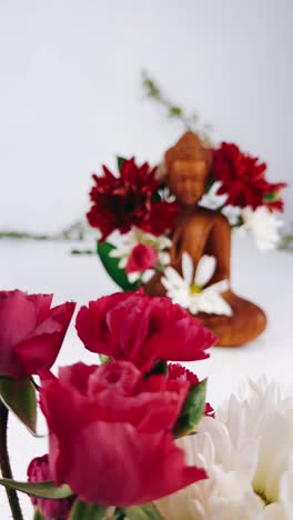 buddha statue and floral arrangement