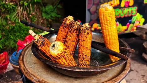 selling street food with grilled corn near ravana waterfall in sri lanka. close-up shot