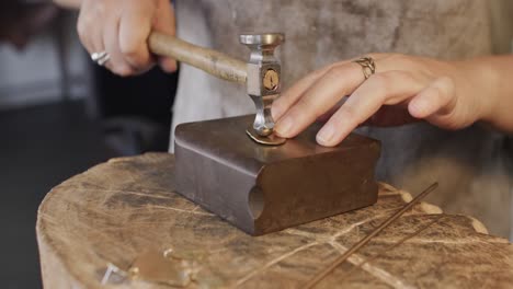 Caucasian-female-worker-shaping-jewellery-in-studio-in-slow-motion