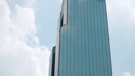 coex wtc trade tower glassy building against cloudy sky, seoul, south korea