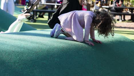 kids climbing and playing on playground hill