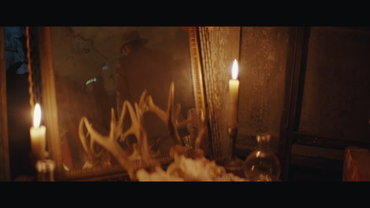 A man in hat arranges dead perfomancer body inside the circus cart