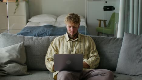 hombre trabajando desde casa en una computadora portátil