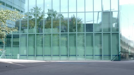 businesswoman with phone in hand runs cheering and enthusiastically in front of an office complex