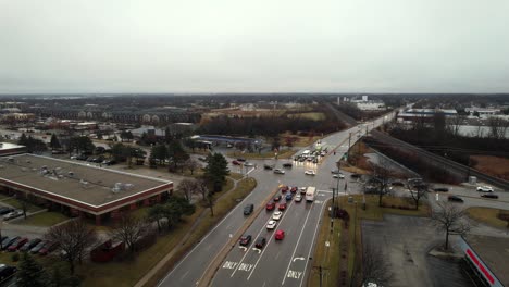 Vernon-Hills,-Illinois-intersection-Townline-rd-with-butterfield-rd-at-sunset-rush-hour-on-rainy-day-aerial-4k