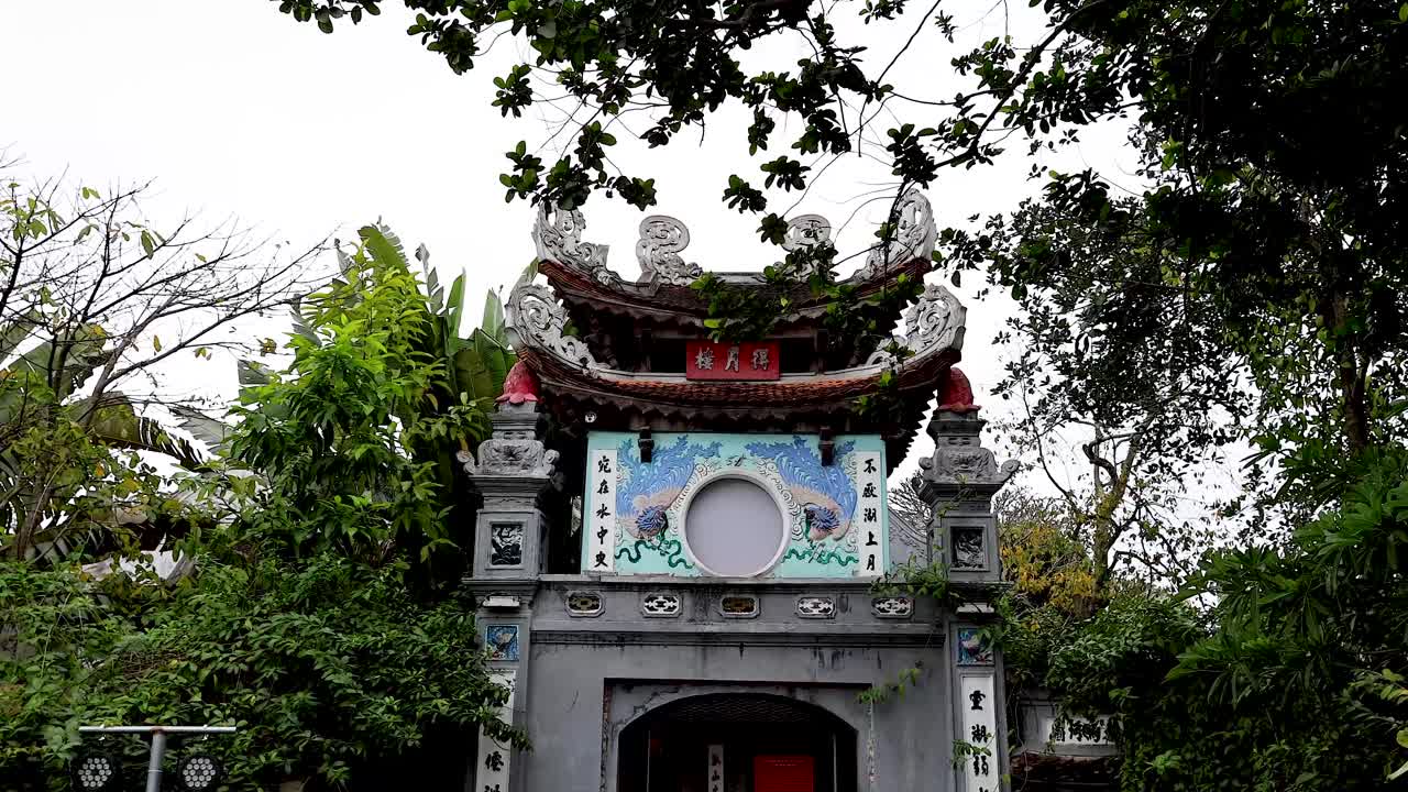 A serene temple entrance surrounded by greenery