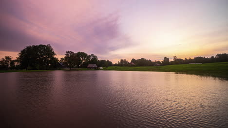 Colorful-timelapse-from-sunrise-to-a-rainy-evening-at-a-lake-in-Europe