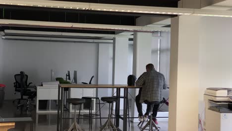 Two-businessman-discussing-work-issues-and-looks-through-the-documents-in-cafe